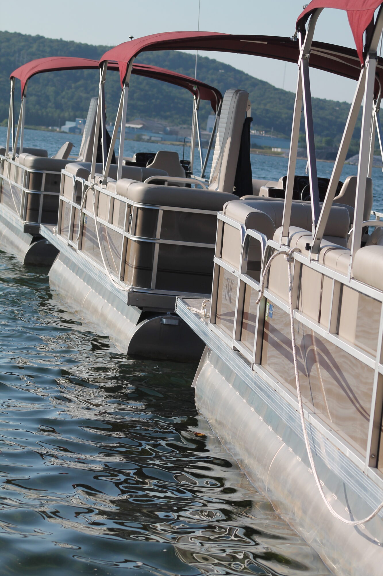 Three pontoons on water at Pontoon on lake at Seaberg Pontoon Rentals